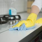 Closeup,Of,Female,Hands,In,Rubber,Yellow,Gloves,Cleaning,The