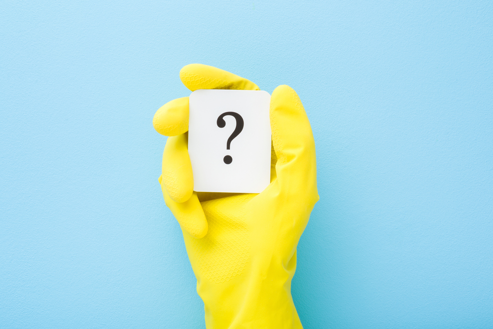 Cleaner,Hand,In,Yellow,Rubber,Protective,Glove,Showing,White,Card