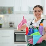 Portrait,Of,Young,Woman,With,Basin,Of,Detergents,In,Kitchen.
