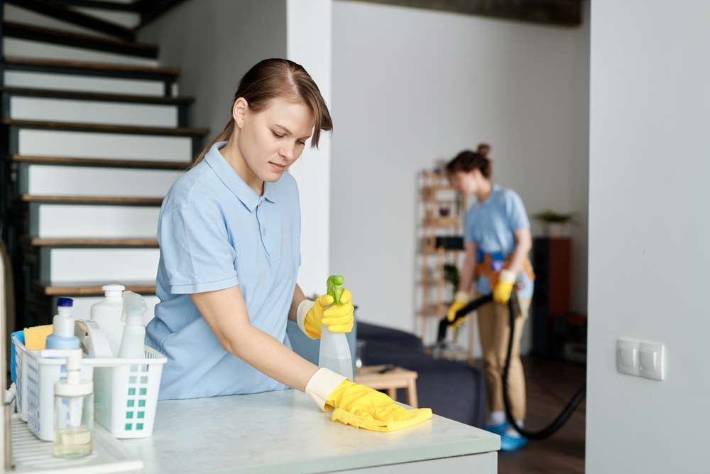 Cleaning,Service,Worker,Wiping,Dust,From,Furniture,With,Rag,And